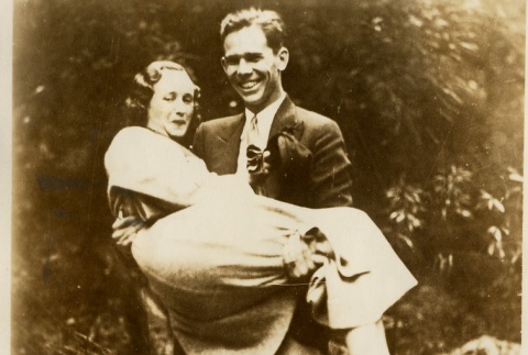 Ellsworth Vines carrying a woman over rocks (ddr-njpa-1-2311)