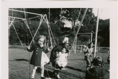 Children on swings at a park (ddr-densho-426-2465)