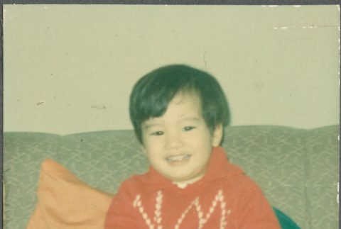 Boy sitting on sofa (ddr-densho-523-558)