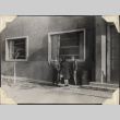 Three men and a woman standing outside building (ddr-densho-466-875)