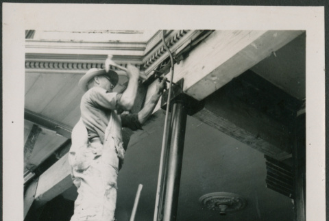 Man hammering bolt into beam (ddr-densho-426-2257)