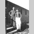 Two men standing in front of barracks at Minidoka concentration camp, Idaho (ddr-densho-243-2)