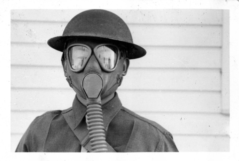 Toshikuni Taenaka in US Army uniform with gas mask (ddr-csujad-25-70)