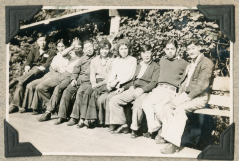 Group of young people sitting on bench (ddr-densho-383-296)