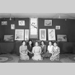 Women sitting in front of an art exhibit (ddr-fom-1-689)