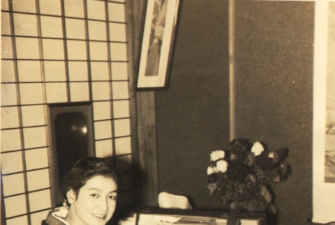 Woman wearing a kimono packing suitcases (ddr-njpa-4-26)
