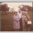 Man and three women with house in background (ddr-densho-523-630)