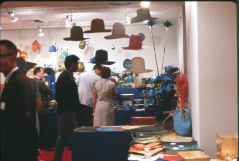 Group of people by hat and placemat display (ddr-densho-426-369)