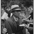 Japanese American man preparing to board the bus (ddr-densho-151-167)