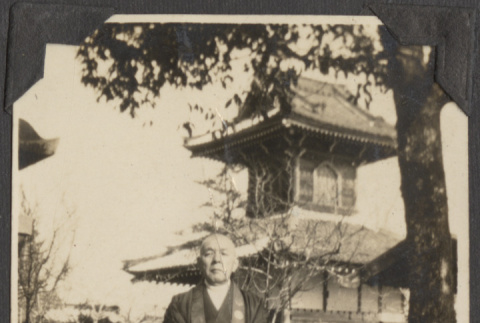Priest standing in front of a temple (ddr-densho-432-106)