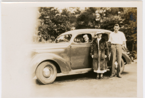 Man and woman standing next to car, woman in driver's seat (ddr-densho-426-1852)