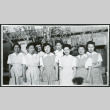 Photograph of eight hospital staff aides standing in front of the Manzanar hospital (ddr-csujad-47-196)