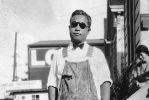 Man standing in overalls (ddr-ajah-6-420)