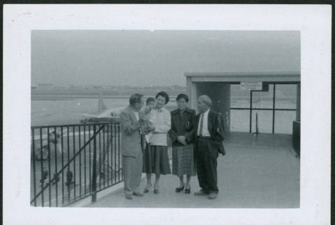 Four adults and a baby at airport (ddr-densho-293-181)
