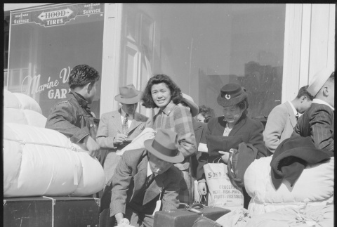 Japanese Americans waiting with baggage (ddr-densho-151-120)