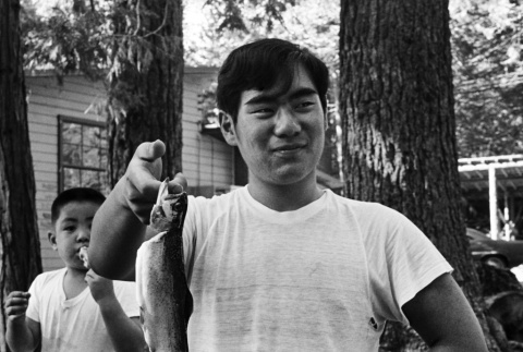 Ted Hasegawa holding a trout (ddr-densho-336-218)
