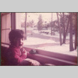 Boy looking out window at snow (ddr-densho-523-555)