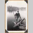 Man poses on a fallen tree (ddr-densho-542-326)