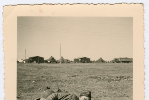Soldier laying on sleeping mat outside (ddr-densho-368-73)