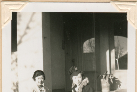 Photo of two women sitting on steps (ddr-densho-341-82)