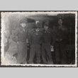 Four men in uniform standing by army truck (ddr-densho-466-8)