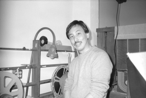 Man with film reels (ddr-densho-1007-557)