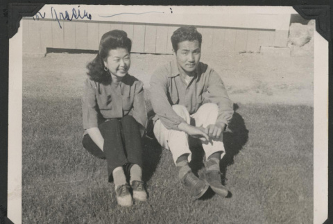 Couple sitting on a lawn (ddr-manz-10-122)