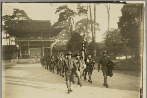 Japanese Boy Scout troop marching with a flag outside a temple (ddr-njpa-13-1187)