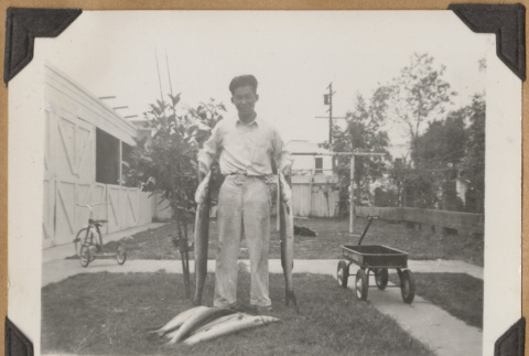 Man with several fish (ddr-densho-542-160)