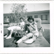 Two girls lounging outside with sodas (ddr-densho-430-217)