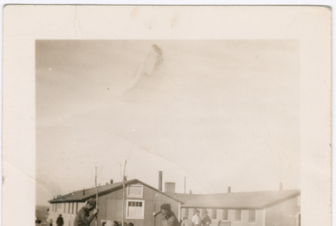 Men planting trees near barracks (ddr-densho-329-1389)