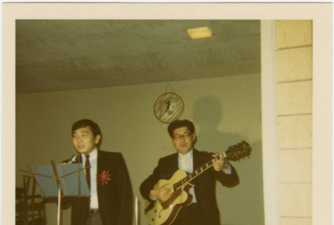 Two men standing at microphone (ddr-densho-426-168)