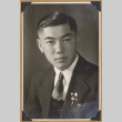Portrait of a man with lapel pins (ddr-densho-542-259)