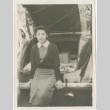 A woman sitting on the bumper of a car (ddr-densho-338-77)