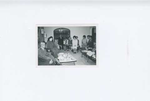 (Photograph) - Image of nun with elderly group of people seated (Front) (ddr-densho-330-283-master-ae9f572fc3)