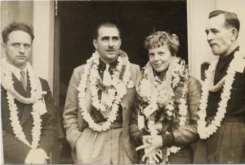 Harry Manning, Paul Mantz, Amelia Earhart, and Fred Noonan wearing leis (ddr-njpa-1-1356)