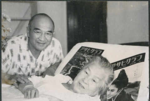 Chester Sakura, St., sitting by Hideko Kondo laying in bed (ddr-densho-523-332)