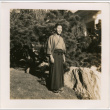Man standing in garden by large rock (ddr-densho-426-2073)