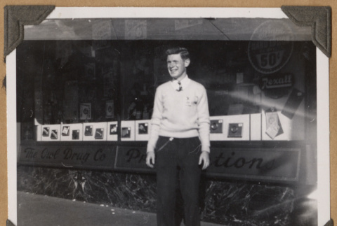 Man standing outside The Owl Drug Co. (ddr-densho-542-62)
