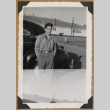 Gary Kikawa poses beside a car (ddr-densho-542-151)