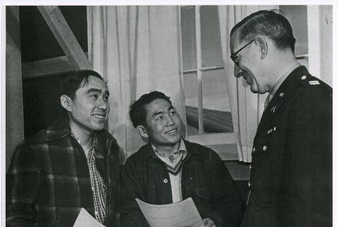 Two young Nisei men signing enlistment papers (ddr-densho-122-756)