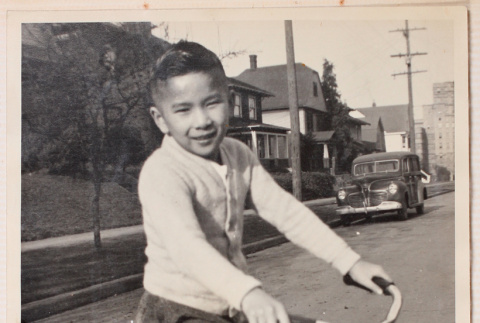 Photo of a boy on a bicycle (ddr-densho-483-420)