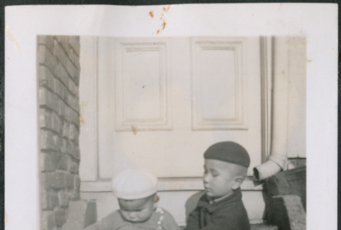 Two boys sitting on stoop (ddr-densho-483-537)