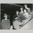 Group of people on aircraft ramp welcoming woman in kimono (ddr-densho-332-36)