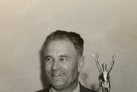 Man standing with trophy (ddr-njpa-2-325)