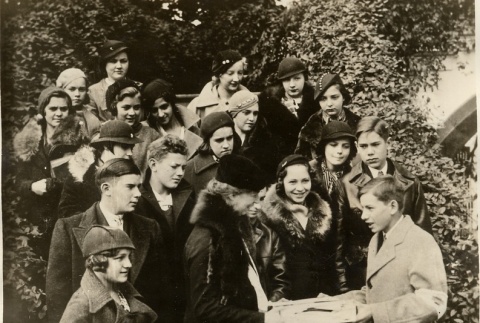 Eleanor Roosevelt receiving a gift from a group of teenagers (ddr-njpa-1-1532)