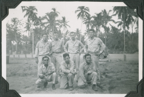 Seven men posing for photo by trees (ddr-ajah-2-668)