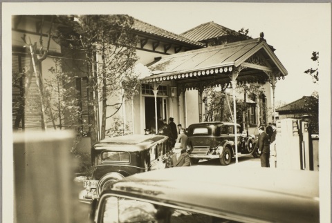 Cars pulling up to a building entry way (ddr-njpa-13-1240)