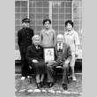 Portrait of Hashiguchi family holding photo of Kenji Hashibushi (ddr-densho-474-190)