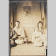 A family posing next to a shrine [?] (ddr-densho-278-58)